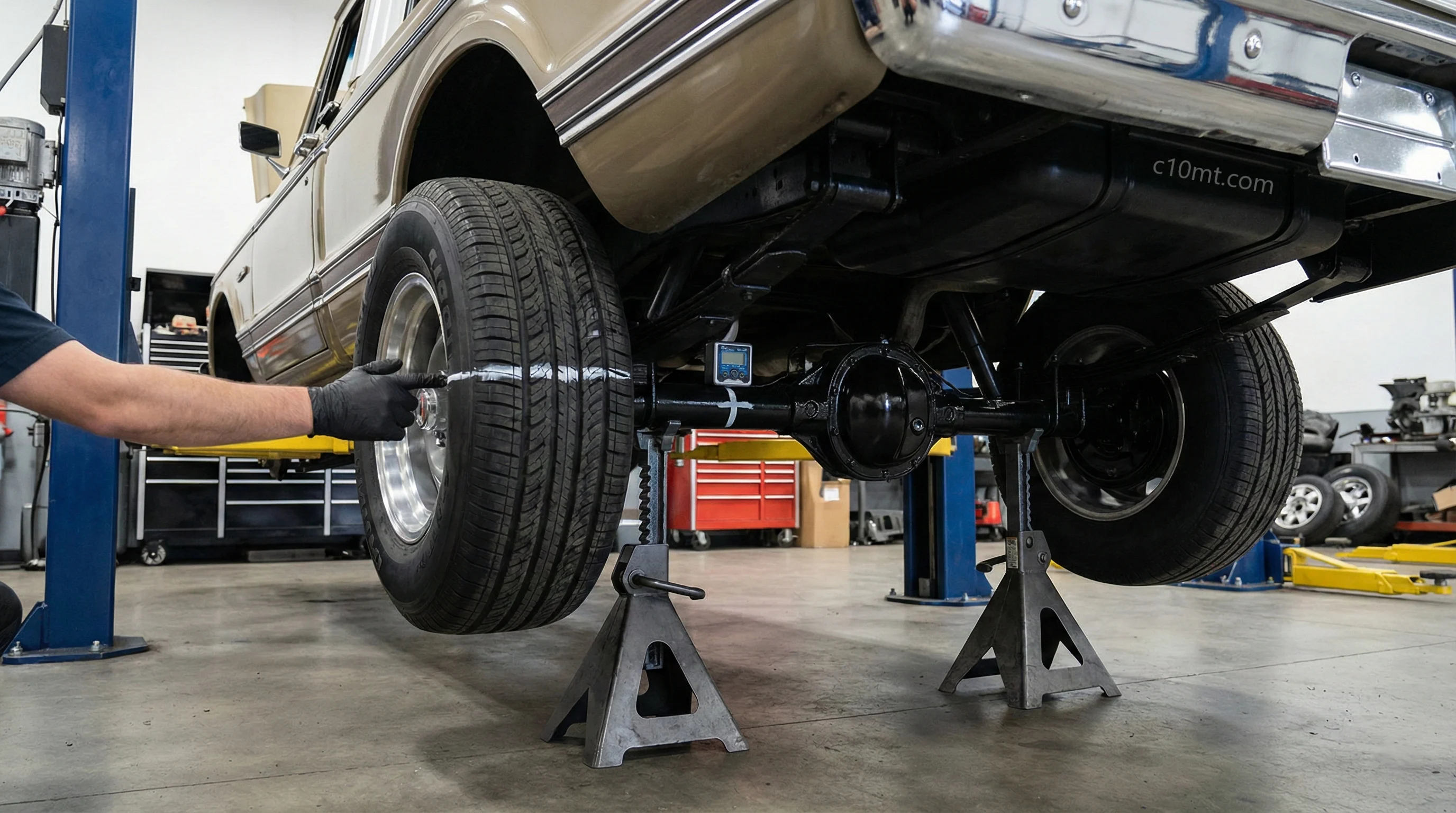 Technician performing a jack-stand gear ratio test on a Chevrolet C10 rear axle