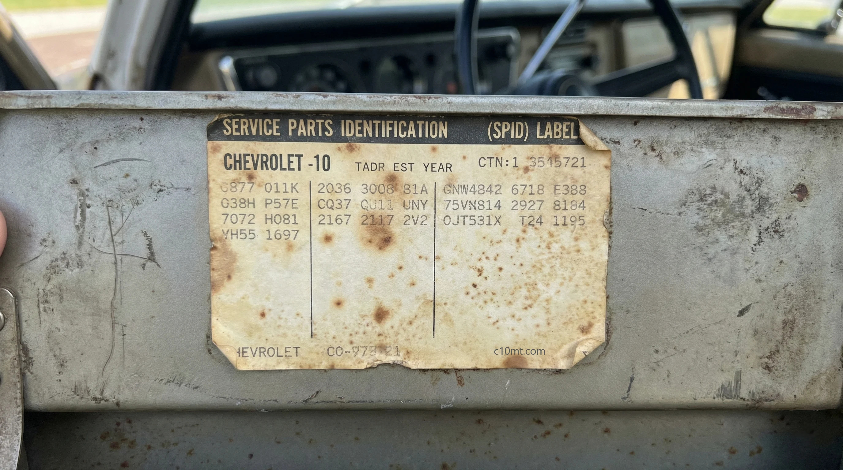 Technical inspection of an authentic Chevrolet C10 SPID label showing RPO codes and age-related foxing